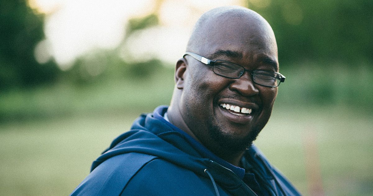 Middle-aged man smiling to camera.