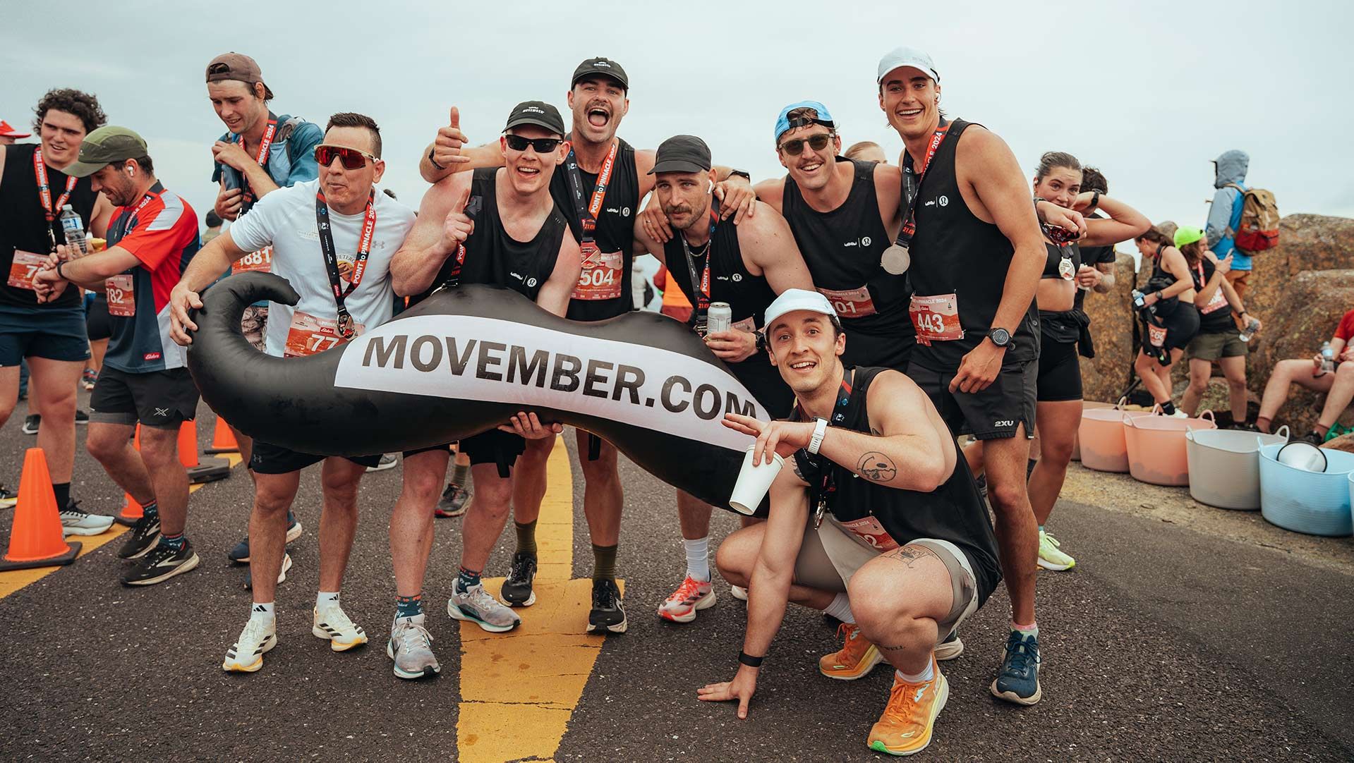 Photo of athletic runners celebrating at the finish, at the Peak to Pinnacle half-marathon in Hobart.